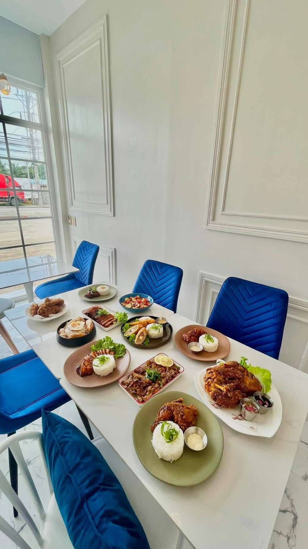 Inside the Home Meals Kitchen dining room in Panabo City, tables set with house dishes