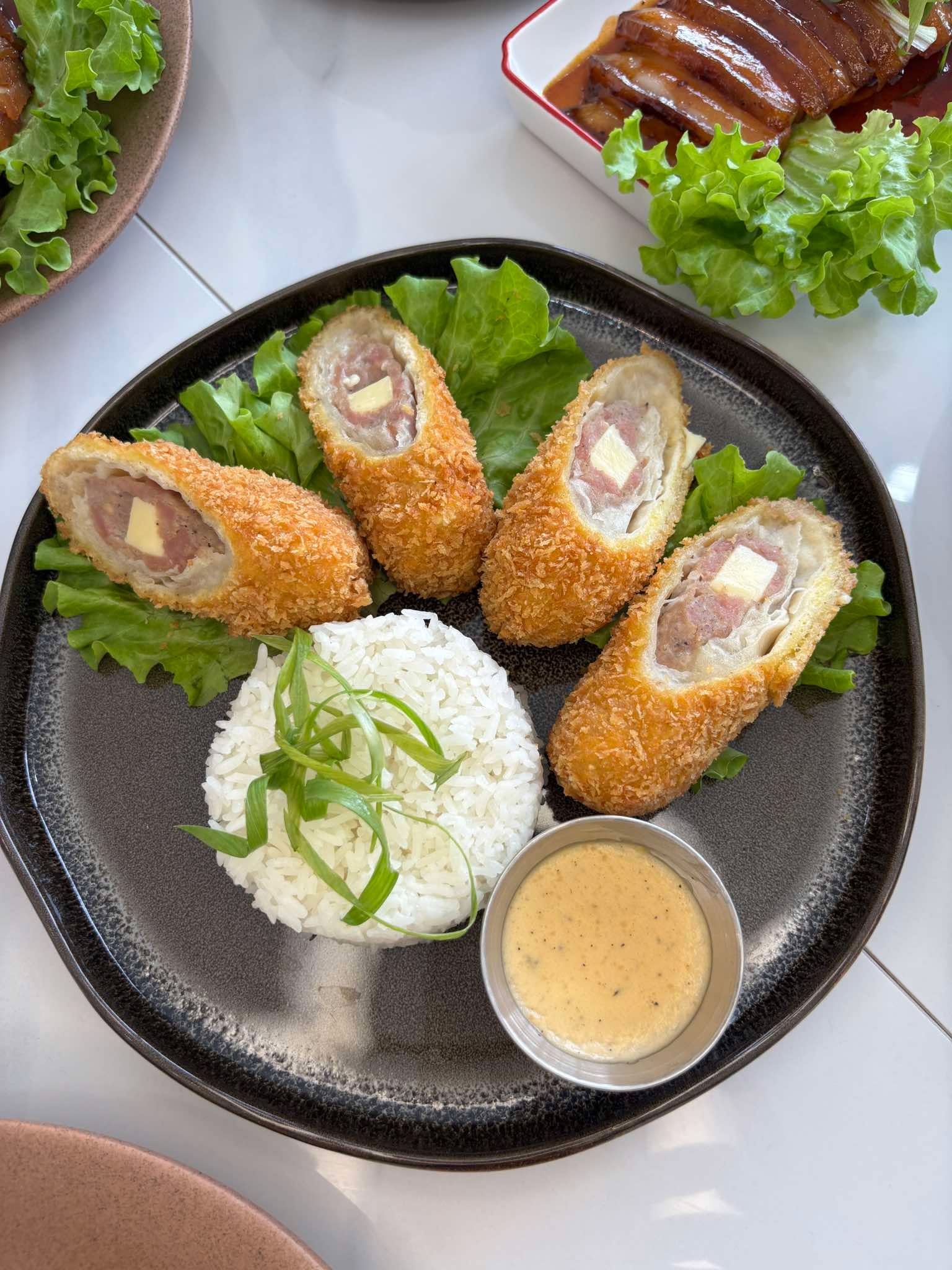 Cordon bleu slices plated with rice and house gravy
