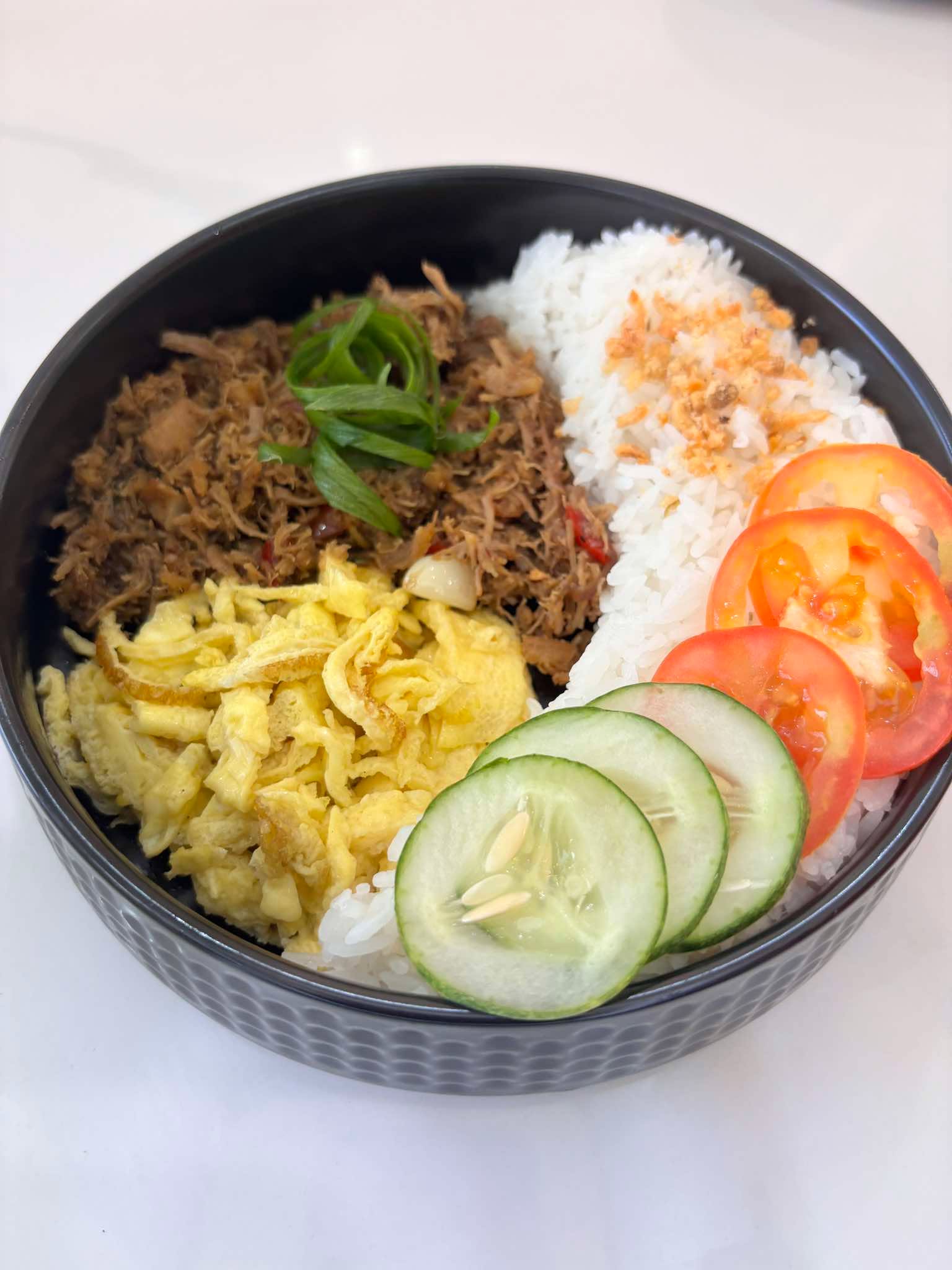 Adobo flakes rice bowl with egg, tomato, and cucumber